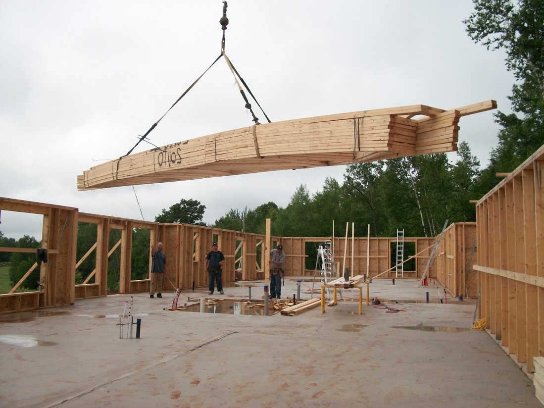 Boom trucks pulling multi-tonned truss trailers don